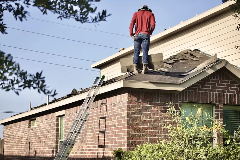Professional roofer working on a residential roof in Ginghamsburg